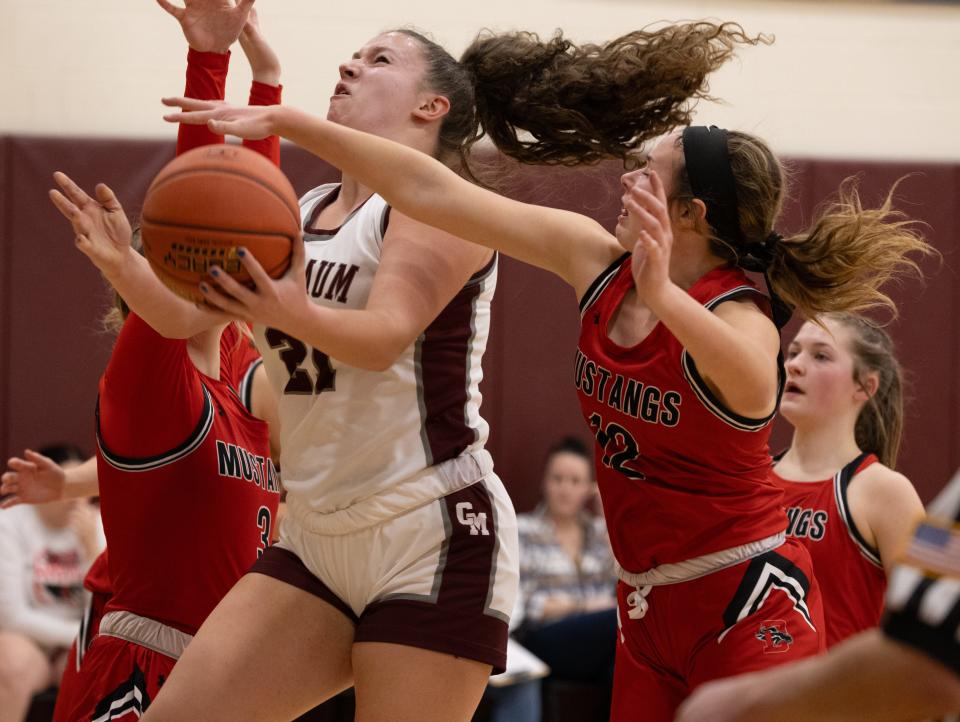 Caledonia-Mumford's Hazell Nickerson draws a foul against Dansville's Chelsie Tyler, right, Wednesday, Jan. 17 at Caledonia-Mumford High School.