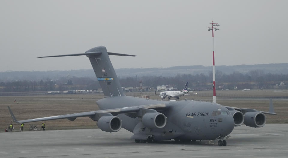 A U.S. Army transport plane lands at the Rzeszow-Jasionka airport in southeastern Poland on Sunday, Feb. 6, 2022, bringing from Fort Bragg troops and equipment of the 82nd Airborne Division. Additional U.S. troops are arriving in Poland after President Joe Biden ordered the deployment of 1,700 soldiers here amid fears of a Russian invasion of Ukraine. Some 4,000 U.S. troops have been stationed in Poland since 2017. (AP Photo/Czarek Sokolowski)