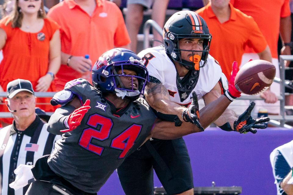 TCU cornerback Josh Newton, left, deflects a pass intended for Oklahoma State's Braydon Johnson last season. An All-Big 12 player in 2022, Newton returns to lead a loaded Horned Frogs secondary.