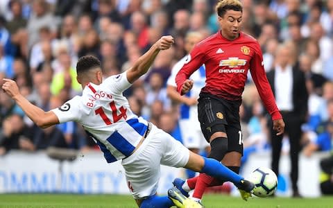 Manchester United's English midfielder Jesse Lingard (R) takes on Brighton's German-born Nigerian defender Leon Balogun (L) during the English Premier League football match between Brighton and Hove Albion and Manchester United - Credit: AFP