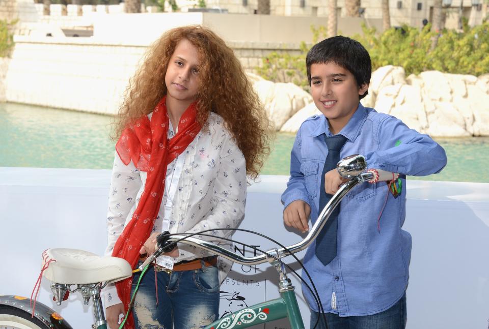 DUBAI, UNITED ARAB EMIRATES - DECEMBER 12: Actors Waad Mohammed and Abdulrahman al Guhani attend the "Wadjda" photocall during day four of the 9th Annual Dubai International Film Festival held at the Madinat Jumeriah Complex on December 12, 2012 in Dubai, United Arab Emirates. (Photo by Andrew H. Walker/Getty Images for DIFF)