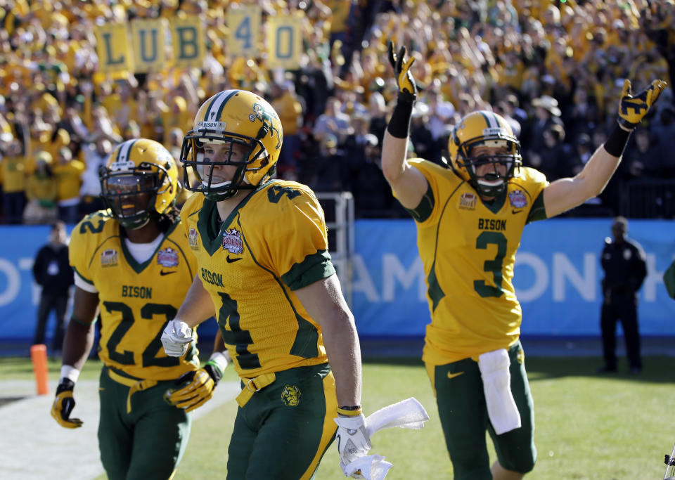 North Dakota State's Sam Ojuri, left, Ryan Smith (4), and Trevor Gebhart (3) celebrate a touchdown by Smith in the first half of the FCS championship NCAA college football game against Towson, Saturday, Jan. 4, 2014, in Frisco, Texas. (AP Photo/Tony Gutierrez)