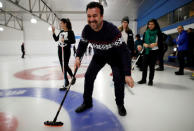 A refugee from Afghanistan smiles as he learns the sport of curling at the Royal Canadian Curling Club during an event put on by the "Together Project", in Toronto, March 15, 2017. REUTERS/Mark Blinch