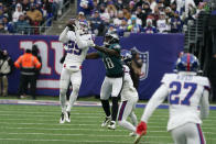 New York Giants' Xavier McKinney, left, intercepts a ball intended for Philadelphia Eagles' Jalen Reagor (18) during the second half of an NFL football game, Sunday, Nov. 28, 2021, in East Rutherford, N.J. (AP Photo/Corey Sipkin)