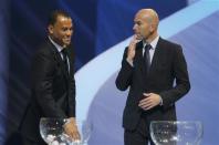 Former French soccer player Zinedine Zidane looks on as former Brazilian soccer player Cafu draws a ball from a pot, during the draw for the 2014 World Cup at the Costa do Sauipe resort in Sao Joao da Mata, Bahia state, December 6, 2013. REUTERS/Paulo Whitaker