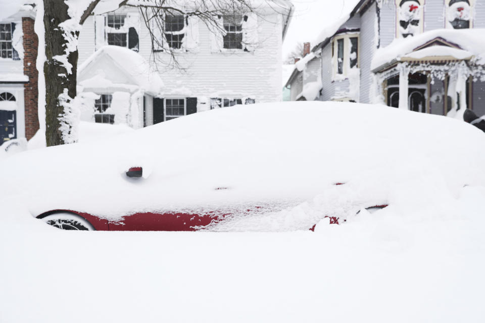 A stranded car is seen in a neighborhood of Buffalo, N.Y.'s Elmwood Village on Monday, Dec. 26, 2022. Clean up is currently under way after a blizzard hit four Western New York counties. (Joseph Cooke/The Buffalo News via AP)