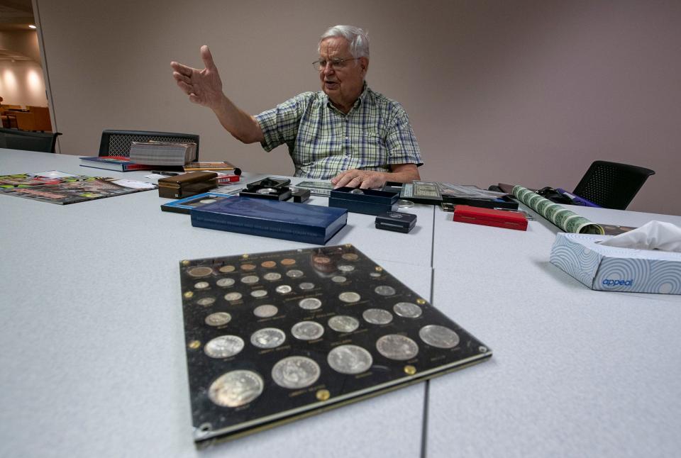 Expert numismatist Gary E. Lewis, former president of both the Cape Coral Coin Club and the Fort Myers Coin Club, displays some of his coins, tokens, medals and paper money that he has collected during a recent presentation.