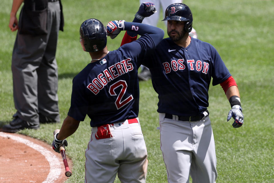 BALTIMORE, MARYLAND - APRIL 11: J.D. Martinez #28 of the Boston Red Sox celebrates with Xander Bogaerts #2 after hitting a solo home run against the Baltimore Orioles in the third inning at Oriole Park at Camden Yards on April 11, 2021 in Baltimore, Maryland. (Photo by Rob Carr/Getty Images)