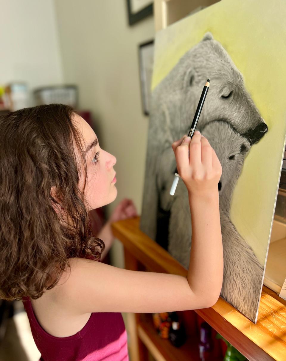 Ella Grace Helton works on a pastel painting of polar bears in November 2023.