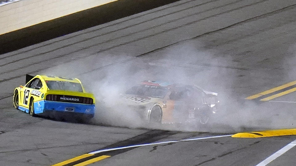 Drivers Ryan Blaney (12) and Chase Elliott (9) crash during the final lap of the NASCAR Daytona Clash auto race Tuesday, Feb. 9, 2021, at Daytona International Speedway in Daytona Beach, Fla. (AP Photo/Chris O'Meara)