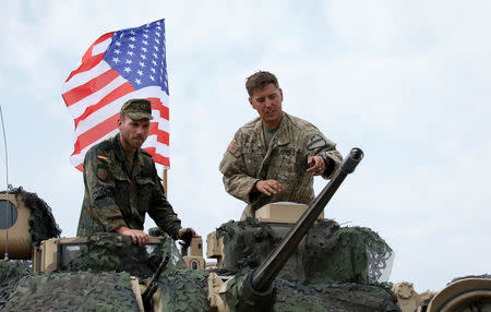 German and U.S. servicemen talk before an opening ceremony of the NATO-led military exercises "Noble Partner 2018" at Vaziani military base outside Tbilisi, Georgia, August 1, 2018. REUTERS/David Mdzinarishvili