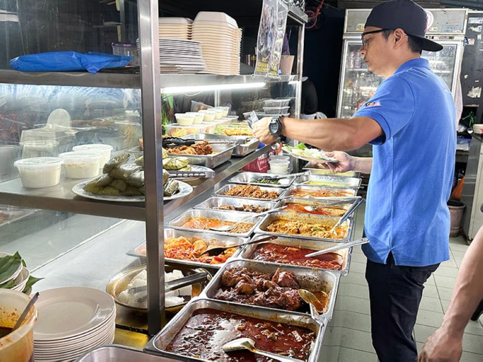 Help yourself to 'nasi lemak' and the spread of dishes for breakfast