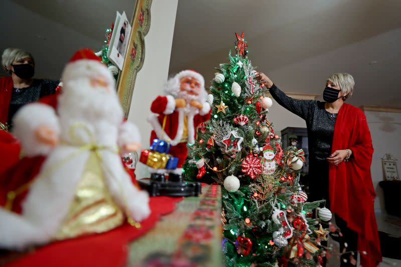 Palestinian Christian woman Ghada Abu Daoud decorates her house ahead of Christmas in Gaza City