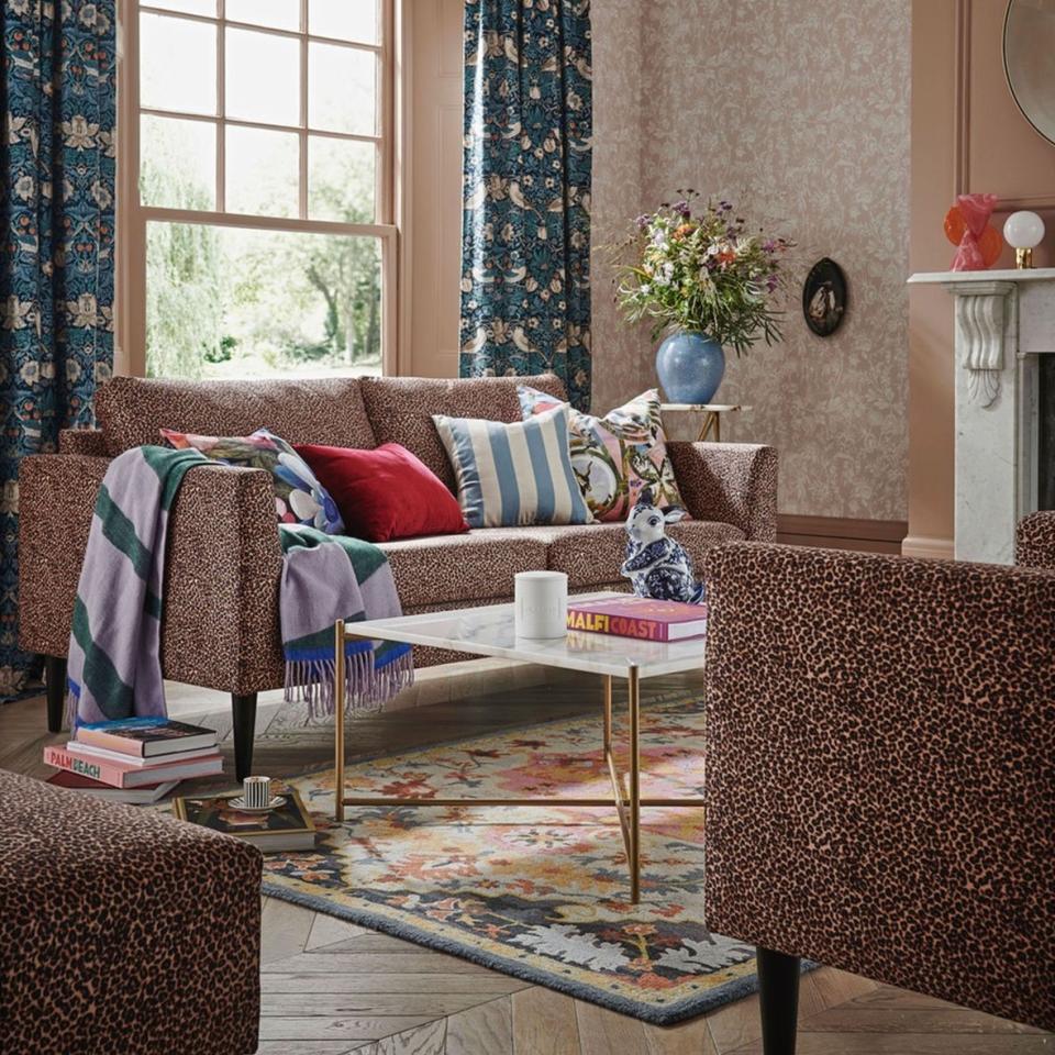 Living room with leopard print sofas and teal patterned sofas