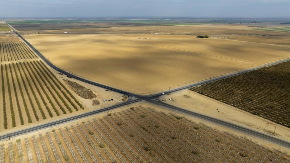 Aerial view of bare land with roads intersecting it.