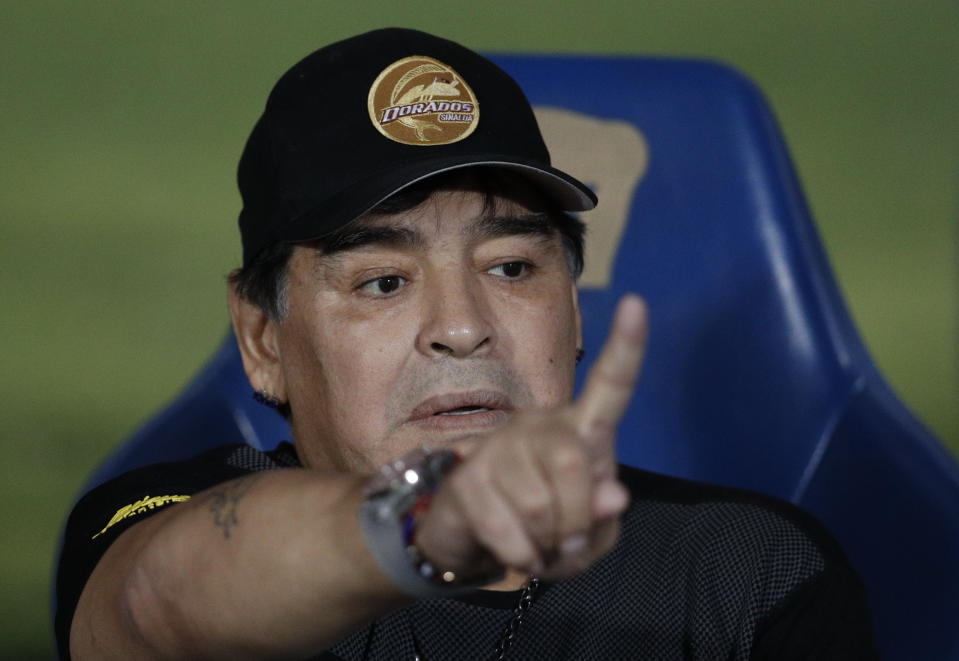 Dorados' Head Coach Diego Maradona gestures as he talks with team staff on the bench ahead of the start of Dorados' Copa MX quarterfinal match against Pumas at Olympic University Stadium in Mexico City, Tuesday, March 12, 2019. Pumas defeated the Dorados 3-0.(AP Photo/Rebecca Blackwell)