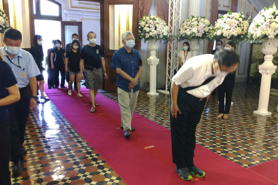 People line up to pay their respects at a memorial for former Taiwanese President Lee Teng-hui in Taipei, Taiwan, Saturday, Aug. 1, 2020. Lee, who brought direct elections and other democratic changes to the self-governed island despite missile launches and other fierce saber-rattling by China, died on Thursday at age 97. (AP Photo/Chiang Ying-ying)