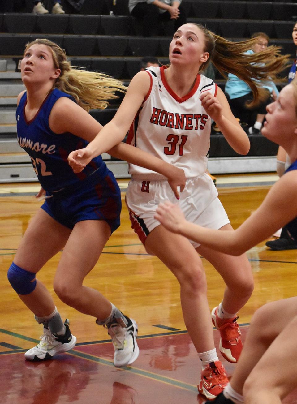 Lily Murray (31) of Honesdale fights for rebounding position during Monday's home opener against Dunmore.