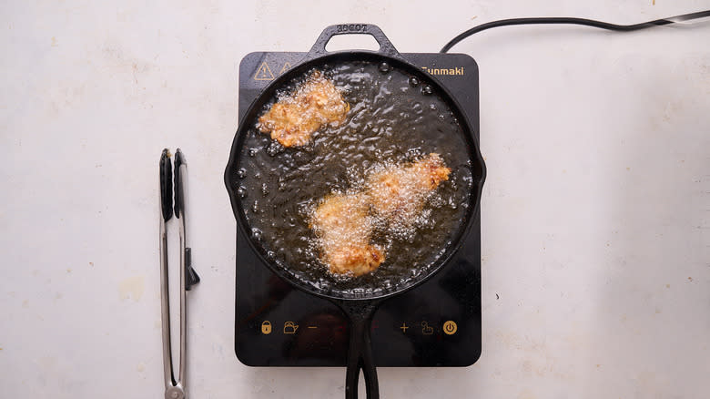 frying chicken in skillet