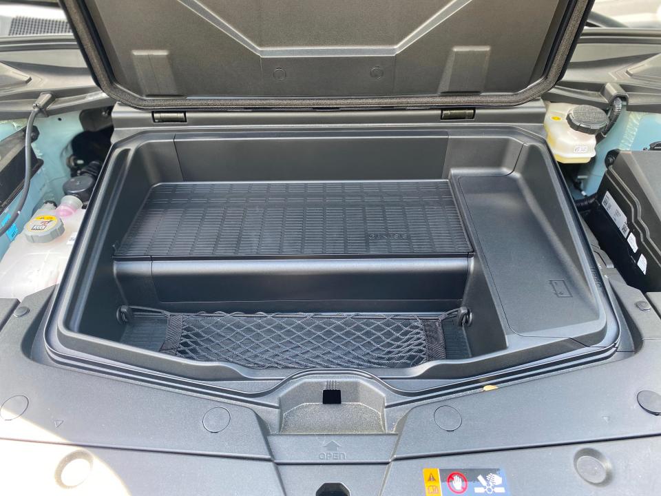 The front cargo compartment under the hood of a 2024 Genesis GV60.