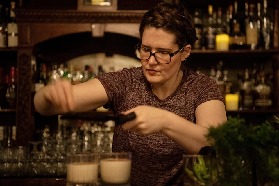 Christine Caldemeyer adds dark chocolate shavings to a Jackie Treehorn cocktail made with lavender-vanilla infused vodka, house made coffee liqueur and cream, at Crow and Quill in Asheville June 22, 2023. 