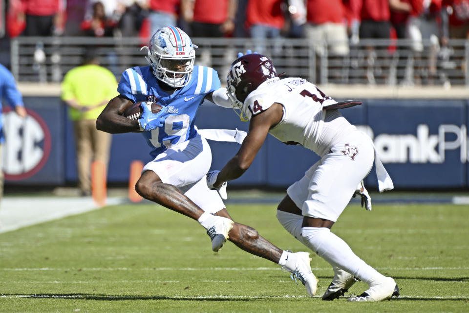 Mississippi wide receiver Dayton Wade (19) looks for room past Texas A&M defensive back Jayvon Thomas (14) during the first half of an NCAA college football game in Oxford, Miss., Saturday, Nov. 4, 2023. Mississippi won 38-35. (AP Photo/Thomas Graning)