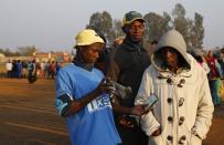 Voters have their documents scanned as they wait to cast their ballots in Bekkersdal, near Johannesburg May 7, 2014. (REUTERS/Mike Hutchings)