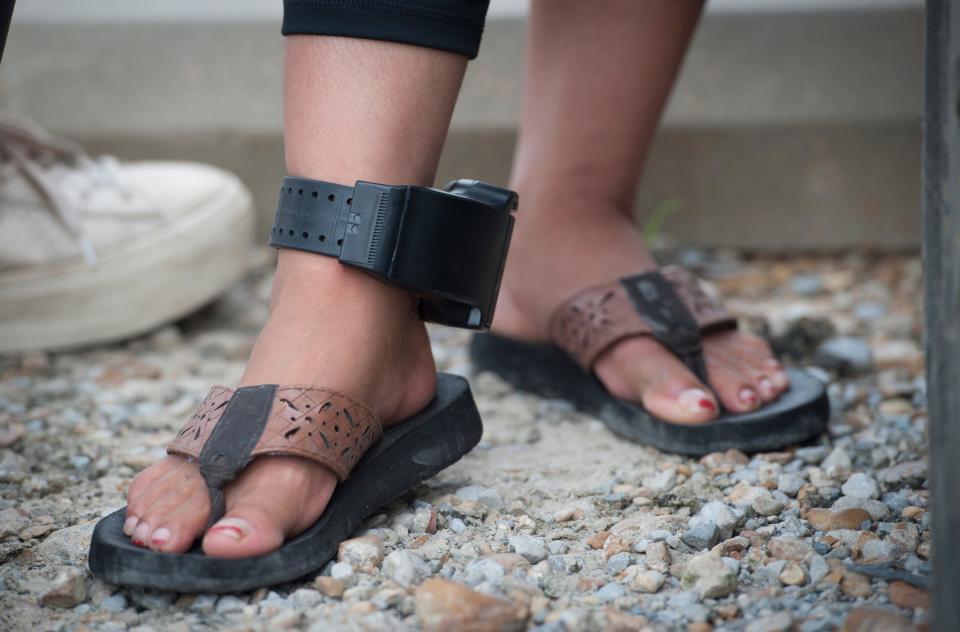 A woman, detained and later released in the Wednesday, Aug. 7, 2019, raids by U.S. immigration officials at the Koch Foods plant in Morton, Mississippi, waits on Thursday, Aug. 8, 2019, with others hoping to find out information about her husband who was also taken. According to a translator, the woman heard her husband had been put on a bus headed to Louisiana. There were 680 people detained in seven raids across the state on Wednesday.