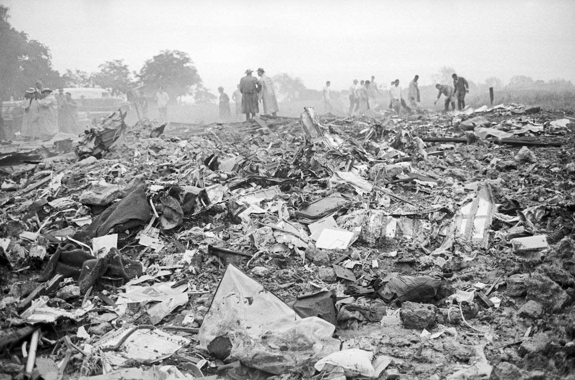 A Braniff International Lockheed Electra plane exploded in midair near the Navarro County town of Dawson, Texas. Pictured are rescue workers attempting to sift through wreckage of the plane.