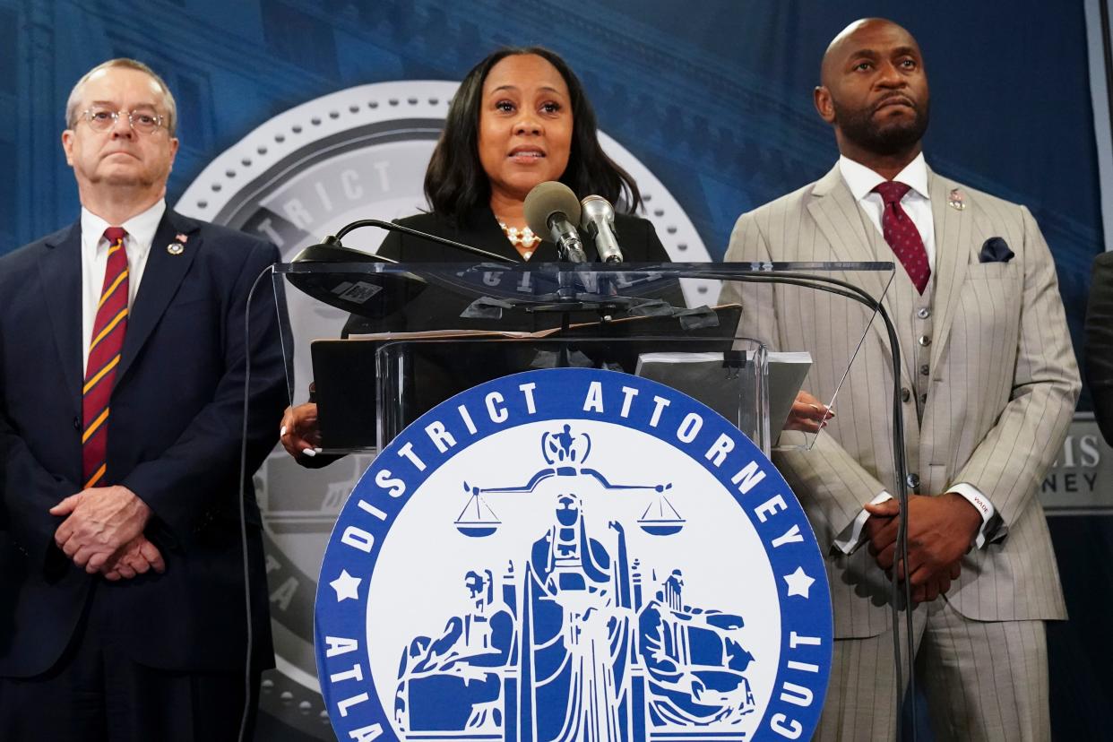 Fulton County District Attorney Fani Willis, center, speaks in the Fulton County Government Center during a news conference, Monday, Aug. 14, 2023, in Atlanta. Donald Trump and several allies have been indicted in Georgia over efforts to overturn his 2020 election loss in the state.