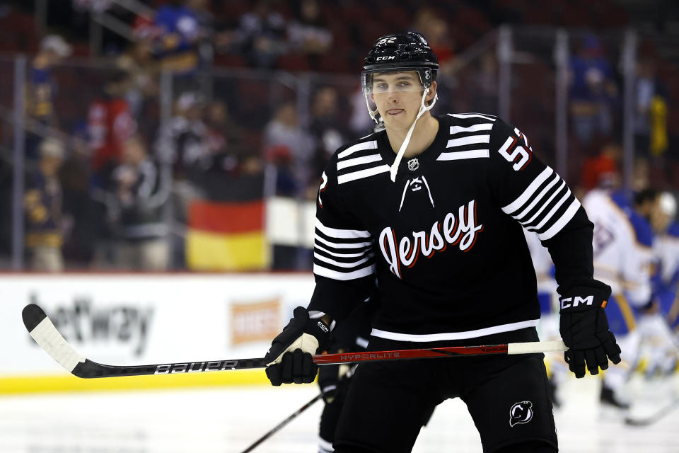 FILE - New Jersey Devils defenseman Cal Foote (52) during warm up before an NHL hockey game, against the Buffalo Sabres Friday, Oct. 27, 2023, in Newark, N.J. Five players from Canada's 2018 world junior team have taken a leave of absence from their respective clubs in recent days amid a report that five members of that team have been asked to surrender to police to face sexual assault charges. New Jersey’s Michael McLeod and Cal Foote, Philadelphia’s Carter Hart, Calgary’s Dillon Dube and former NHL player Alex Formenton have all been granted indefinite leave, with the absences announced this week. (AP Photo/Noah K. Murray, File)