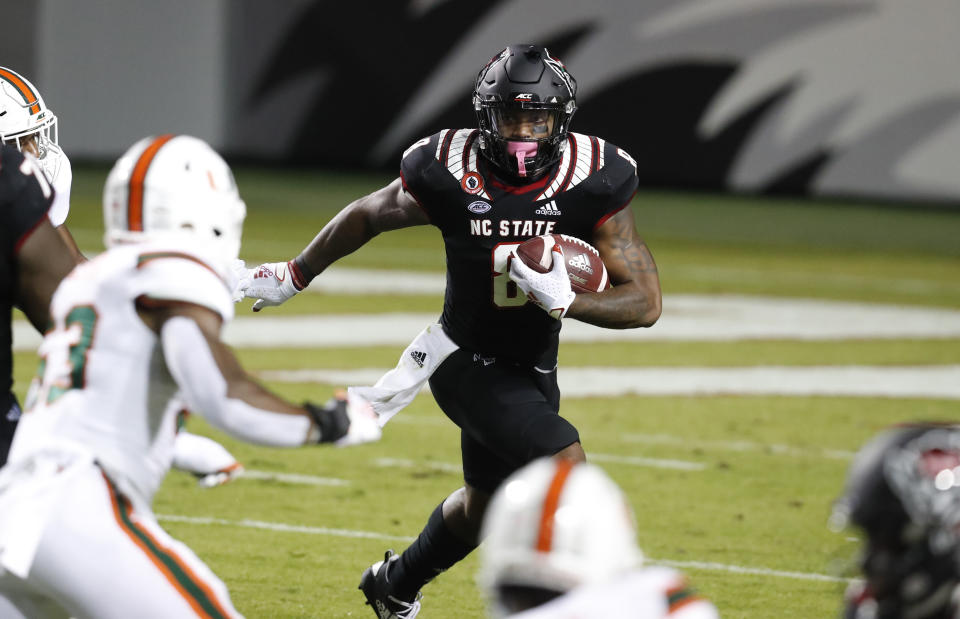 North Carolina State running back Ricky Person Jr. (8) gains yards against Miami during the first half of an NCAA college football game Friday, Nov. 6, 2020, in Raleigh, N.C. (Ethan Hyman/The News & Observer via AP, Pool)