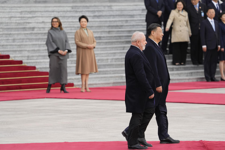 Brazilian President Luiz Inacio Lula da Silva, left, and Chinese President Xi Jinping review the honor guard during a welcome ceremony held outside the Great Hall of the People in Beijing, China, Friday, April 14, 2023. (Ken Ishii/Pool Photo via AP)