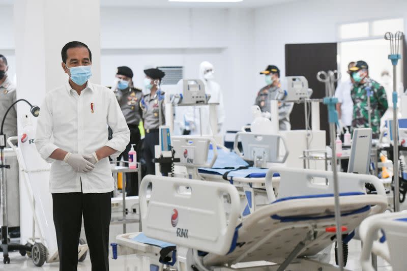 Indonesia's President Joko Widodo takes a look at the emergency hospital handling of COVID-19 in Kemayoran Athletes Village in Jakarta