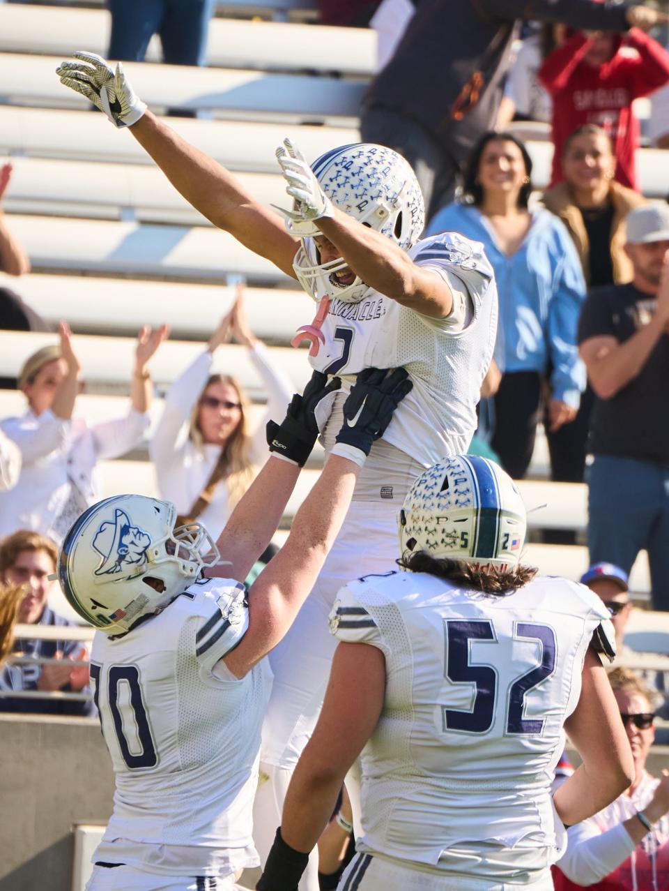 Pinnacle Pioneers wide receiver Duce Robinson (2) is hoisted into the air by defense lineman Travis Gutierrez (70)  after scoring a touchdown against the Highland Hawks during the 6A state championship game at Sun Devil Stadium in Tempe on Saturday, Dec. 10, 2022.