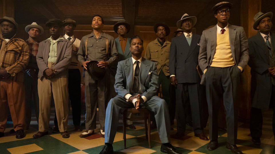 Chris Rock (seated) surrounded by other men in Fargo