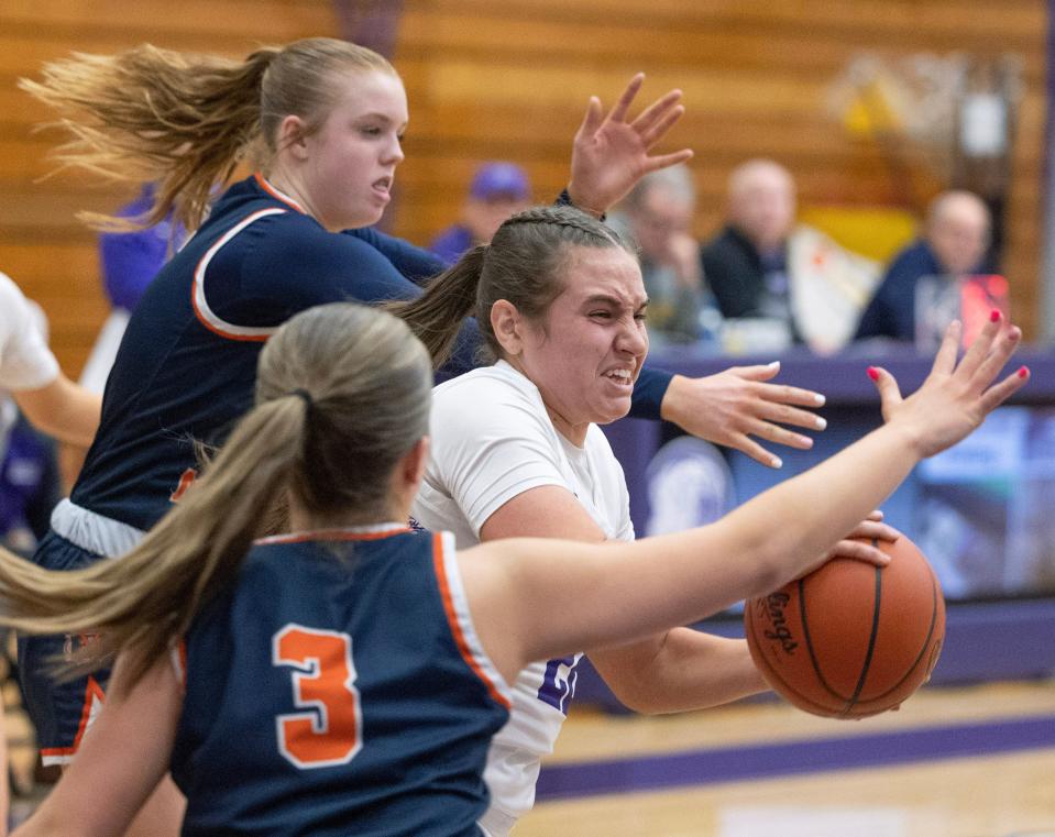Jackson's Megan Campbell splits the defense of Berea -Midpark's Casey Friel and Avery James in the second half during a DI sectional game at Jackson Thursday, Feb. 22, 2024.