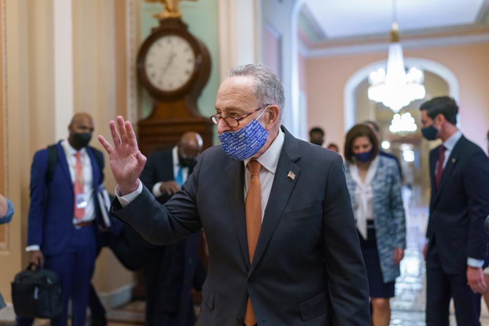 On the first full day of Democratic control, Senate Majority Leader Chuck Schumer, D-N.Y., walks to the chamber after meeting with new senators from his caucus, at the Capitol in Washington, Thursday, Jan. 21, 2021.