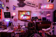 <p>Jon Blake, curator of Gods Own Junkyard and family friend to third generation neon light artist Marcus Bracey sits with some of the exhibits at God’s Own Junkyard gallery and cafe in London, Britain, May 13, 2017. (Photo: Russell Boyce/Reuters) </p>