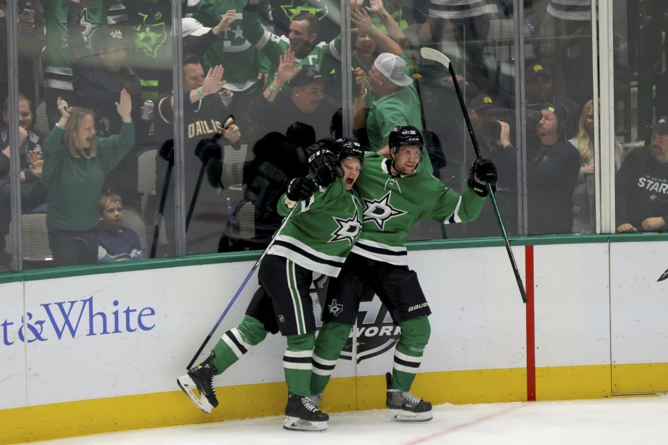 Dallas Stars left wing Joel Kiviranta (25) and center Radek Faksa (12) celebrate after Kiviranta scored in the third period of an NHL hockey game against the Washington Capitals in Dallas, Thursday, Oct. 27, 2022. (AP Photo/Gareth Patterson)