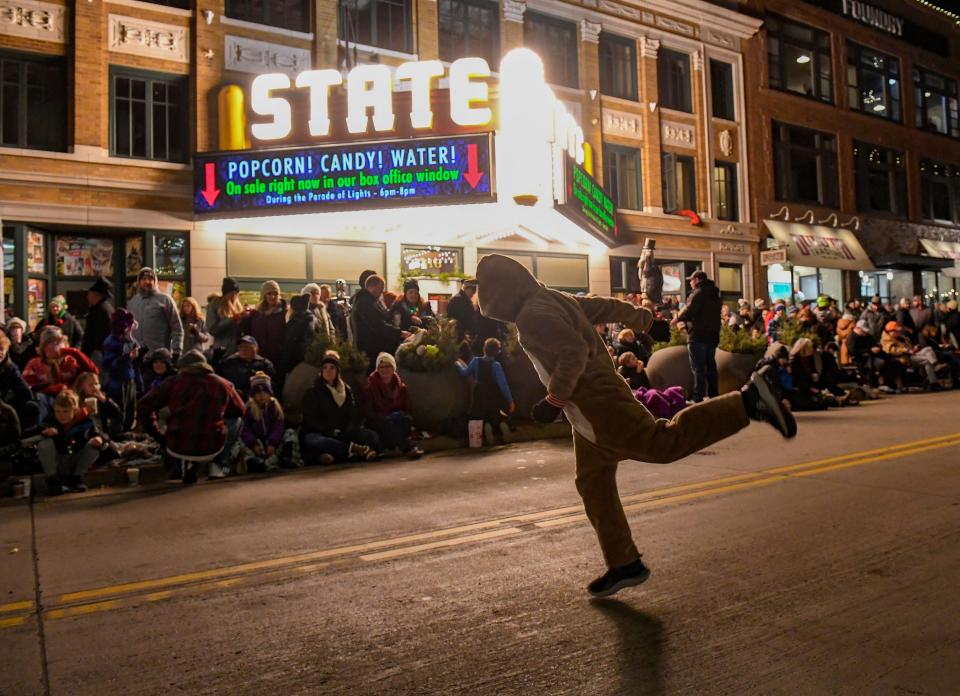 Samuel Buckley, 6, dances in the street wearing a reindeer onesie to "entertain the crowd" before the annual Parade of Lights marches through downtown on Friday, November 26, 2021, in Sioux Falls.