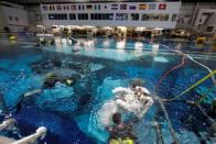 NASA Commercial Crew astronaut Sunita Williams enters the water at NASA's Neutral Buoyancy Laboratory (NBL) training facility near the Johnson Space Center in Houston