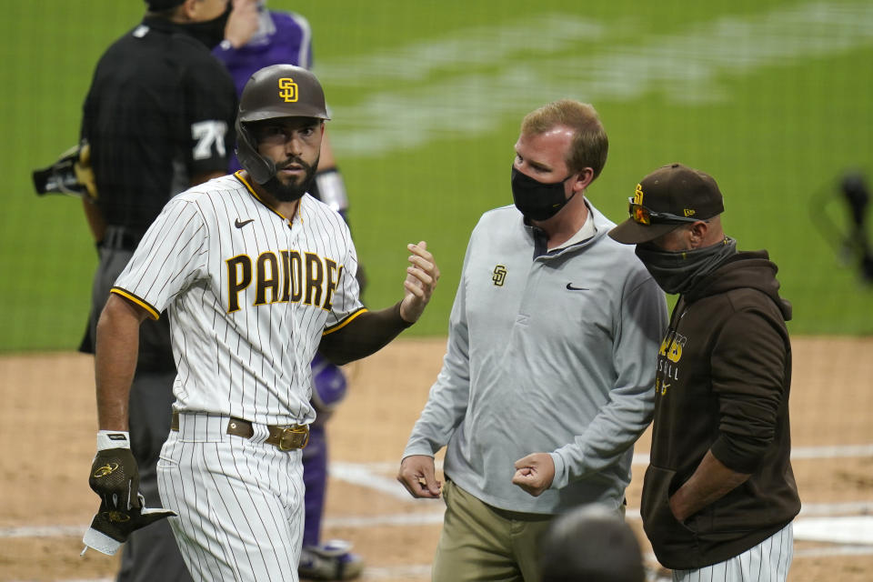 Eric Hosmer holds his injured hand up.