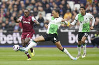 West Ham United's Michail Antonio, left, and Liverpool's Virgil van Dijk battle for the ball during the English Premier League soccer match at the London Stadium, London, Saturday April 27, 2024. (Adam Davy/PA via AP)