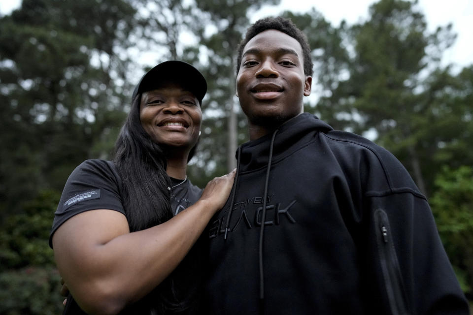 Janel Jones poses with her son, Christian Jones, 17, on Friday, May 17, 2024, in Lawrenceville, Ga. Jones, a divorced veteran in Atlanta with two children, said though she has seen the benefits of choice having sent her 13-year-old daughter and 17-year-old son to seven different schools combined across the country, she feels at though just giving parents an option is not enough. (AP Photo/Mike Stewart)