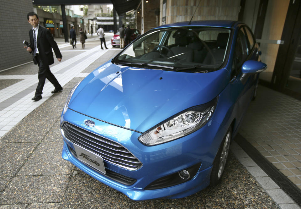 A man looks at a Ford Fiesta compact car in Tokyo Thursday, Jan. 9, 2014. Ford's Fiesta compact is back in Japan despite failing a decade ago in a market dominated by Toyota and other powerful local brands that specialize in small cars. (AP Photo/Koji Sasahara)