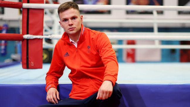 Lewis Richardson sitting on the outside of the ring