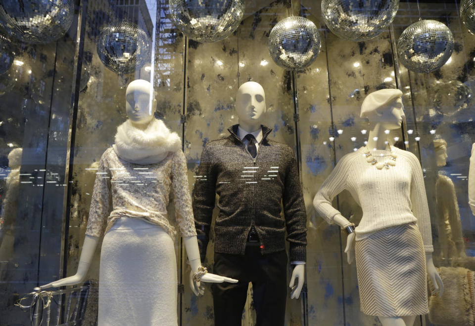 This Nov. 20, 2013 photo shows Banana Republic fashions displayed in a holiday window in New York. Forget window shopping, some of Manhattan’s biggest and most storied retailers say their elaborate seasonal window displays are a gift to passers-by. (AP Photo/Mark Lennihan)