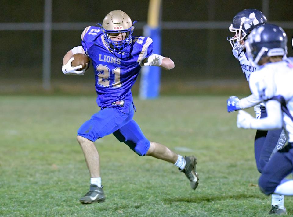 Owen Enright of St. John Paul II prepares to stiff arm Jack McCartty of Monomoy.