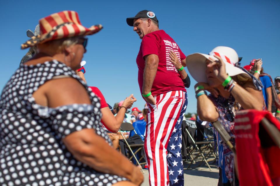 Michael Brian Protzman, also know as Negative48 and the supposed leader of a QAnon cult, talks with supporters before a rally for former President Donald Trump in Wilmington, North Carolina on September 23, 2022.